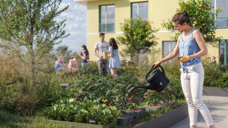 Bewohner gießen Gemüsebeete beim Urban Gardening auf der Dachterrasse des Quartiers ORPLID