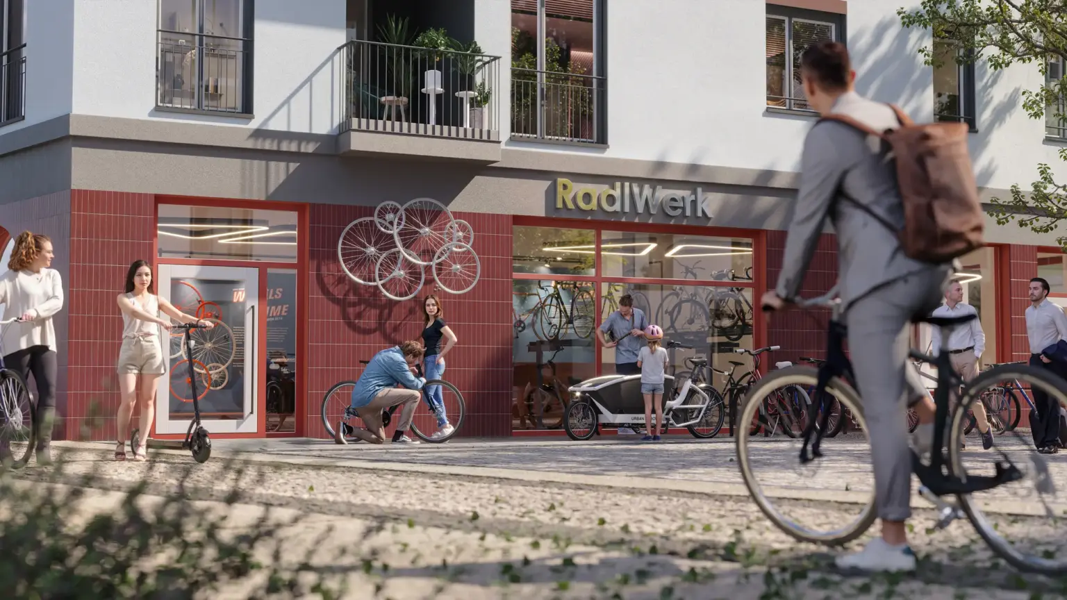 Fahrradgeschäft RadlWerk mit mehreren Personen und Fahrrädern vor dem Eingang.