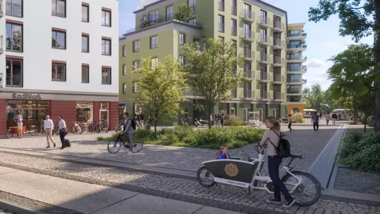 Straßenszene im Wohnquartier ORPLID mit moderner Architektur und Radfahrern